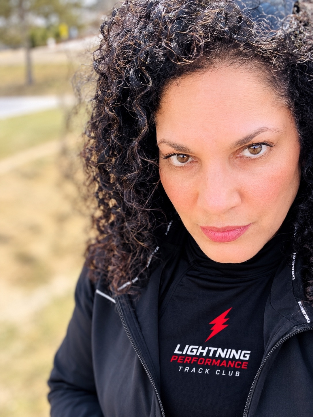 Portrait of Lightning Performance Track Club mid-distance, distance, and jumps coach Anna-Marie Allen