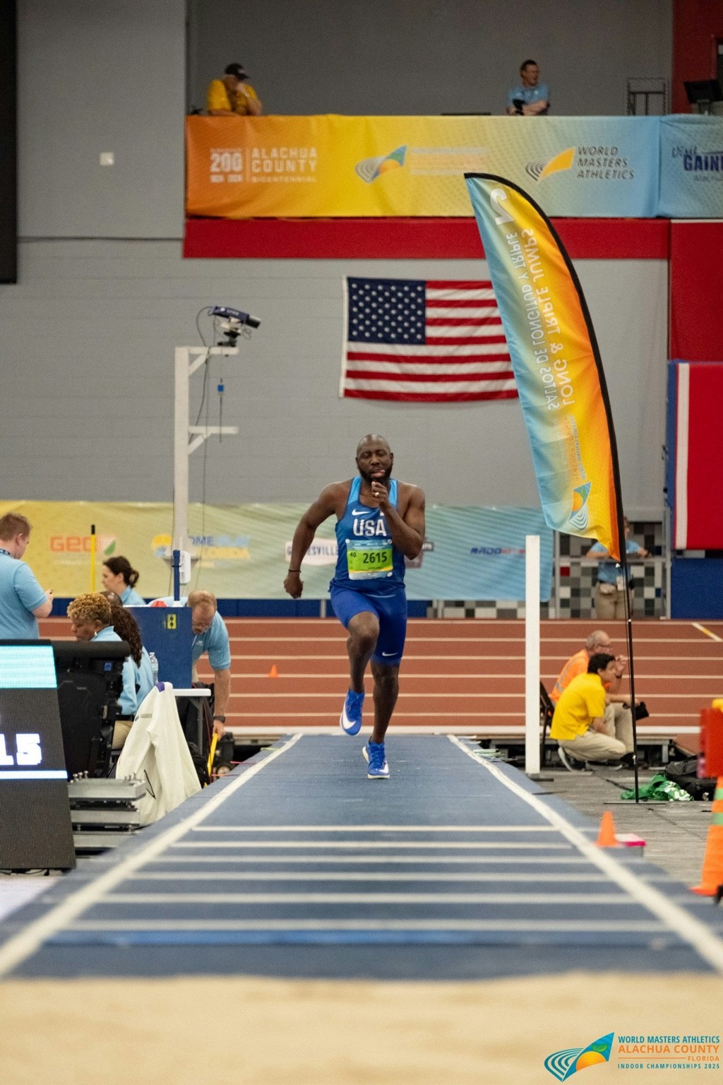 Jason James sprinting down the runway during a long jump competition